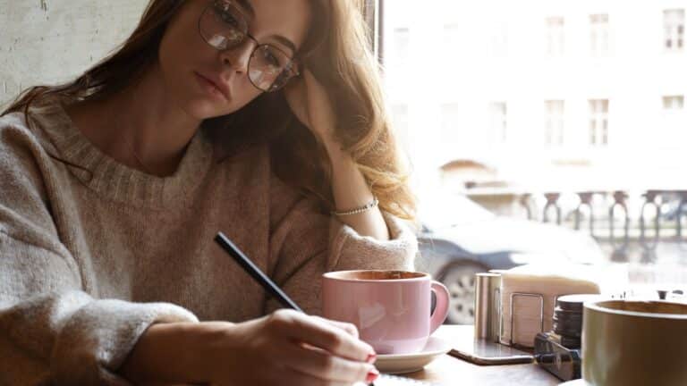 woman writing in journal.