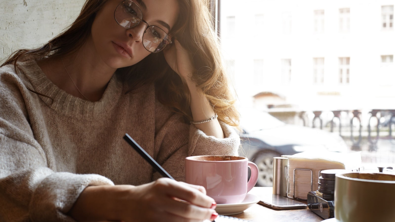 woman writing in journal.