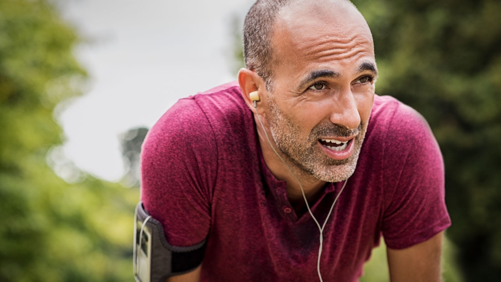 athletic mature man after run in park.