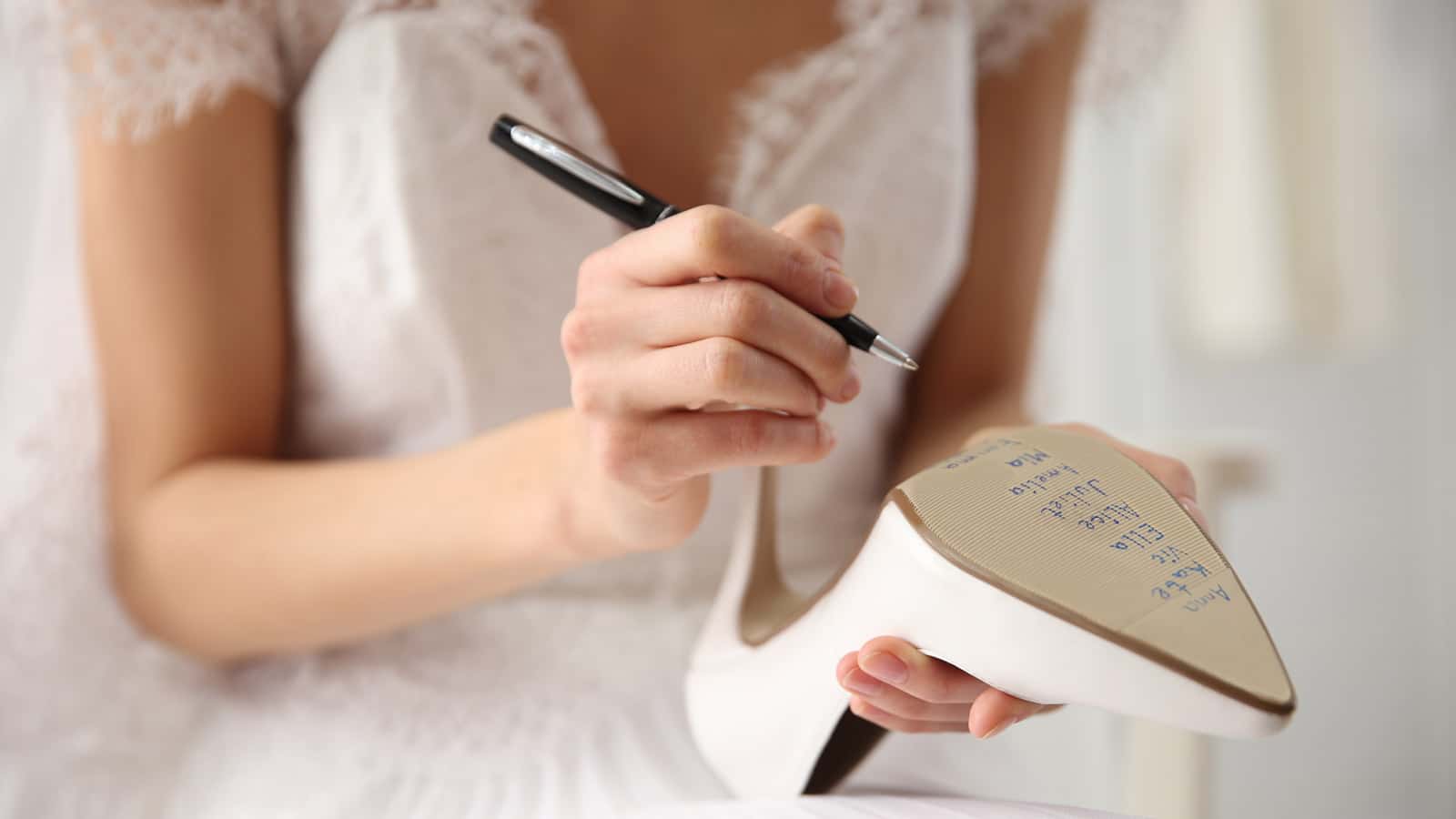 bride writing names on shoe