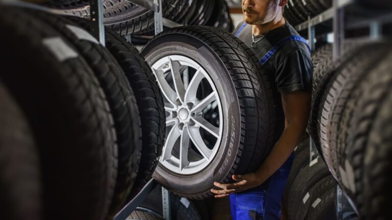 Man lifting car tire