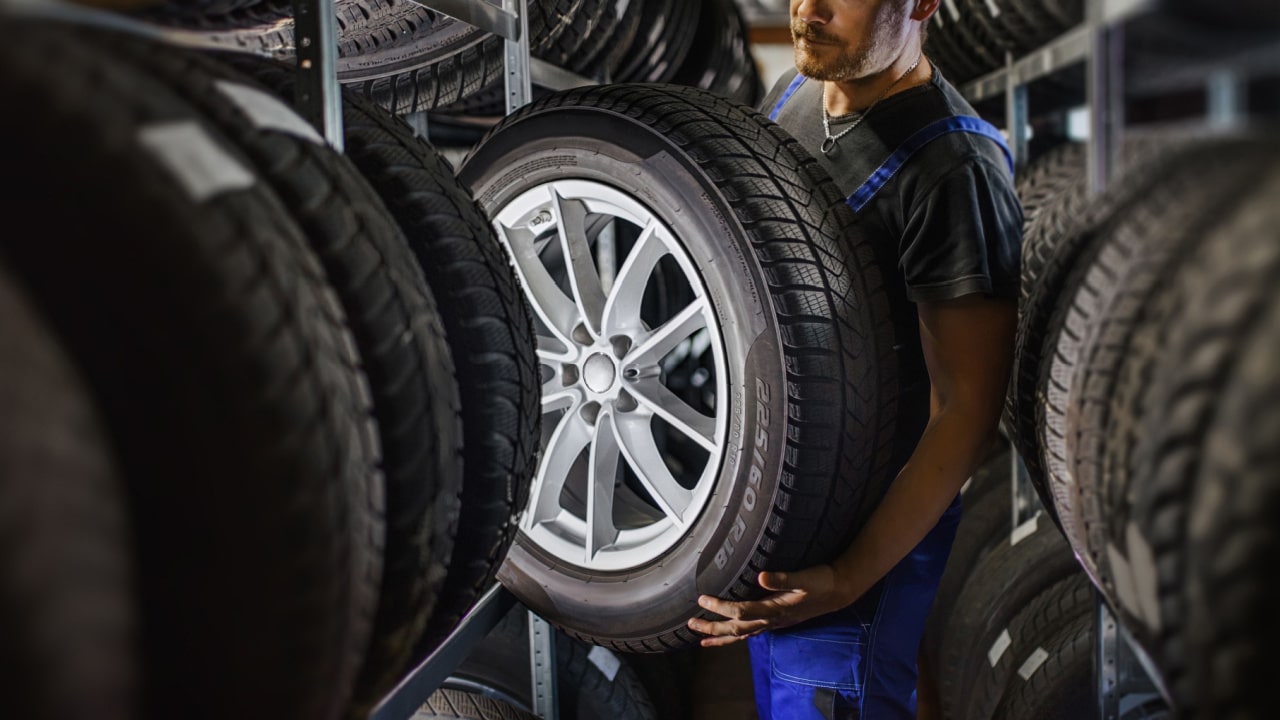 Man lifting car tire