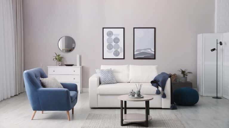 A living room with limited furniture and neutral tones