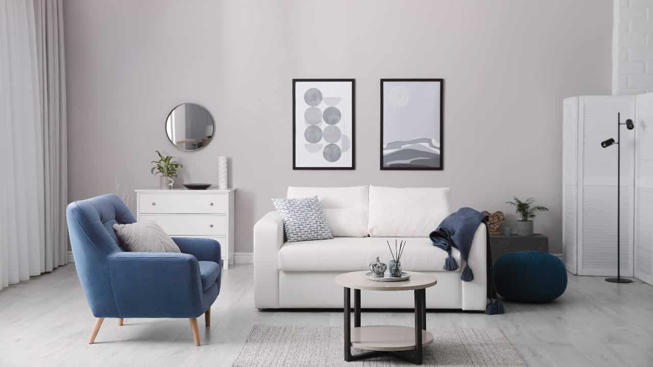 A living room with limited furniture and neutral tones