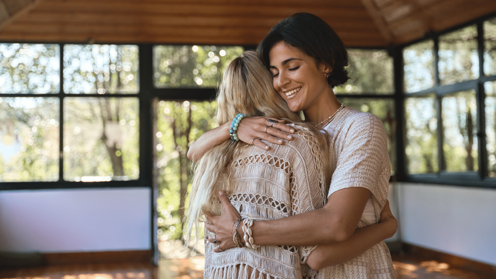 A woman hugging a young woman during spiritual practice feeling gratitude and love.