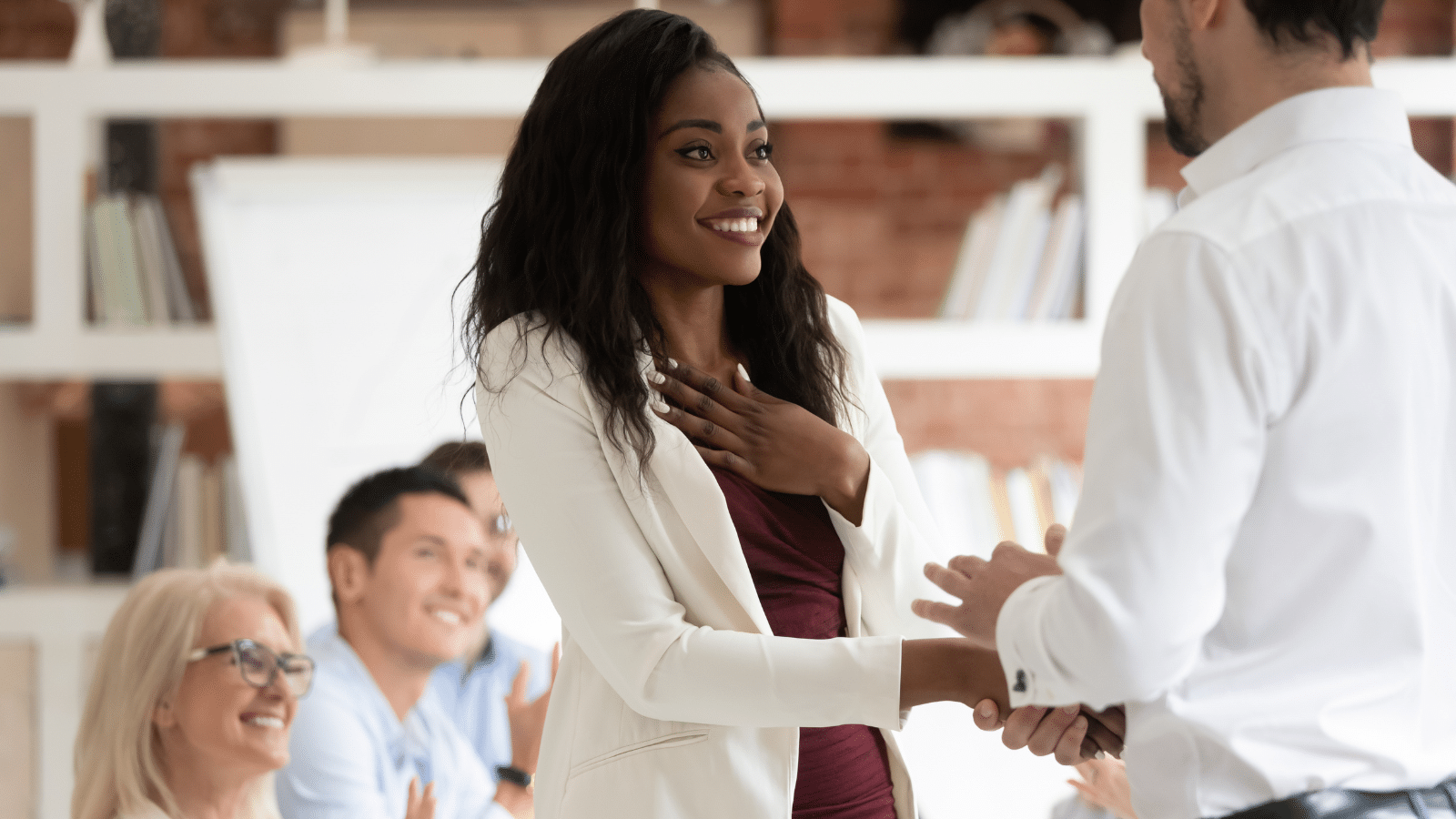 Female employee get rewarded for professional achievement handshake boss.