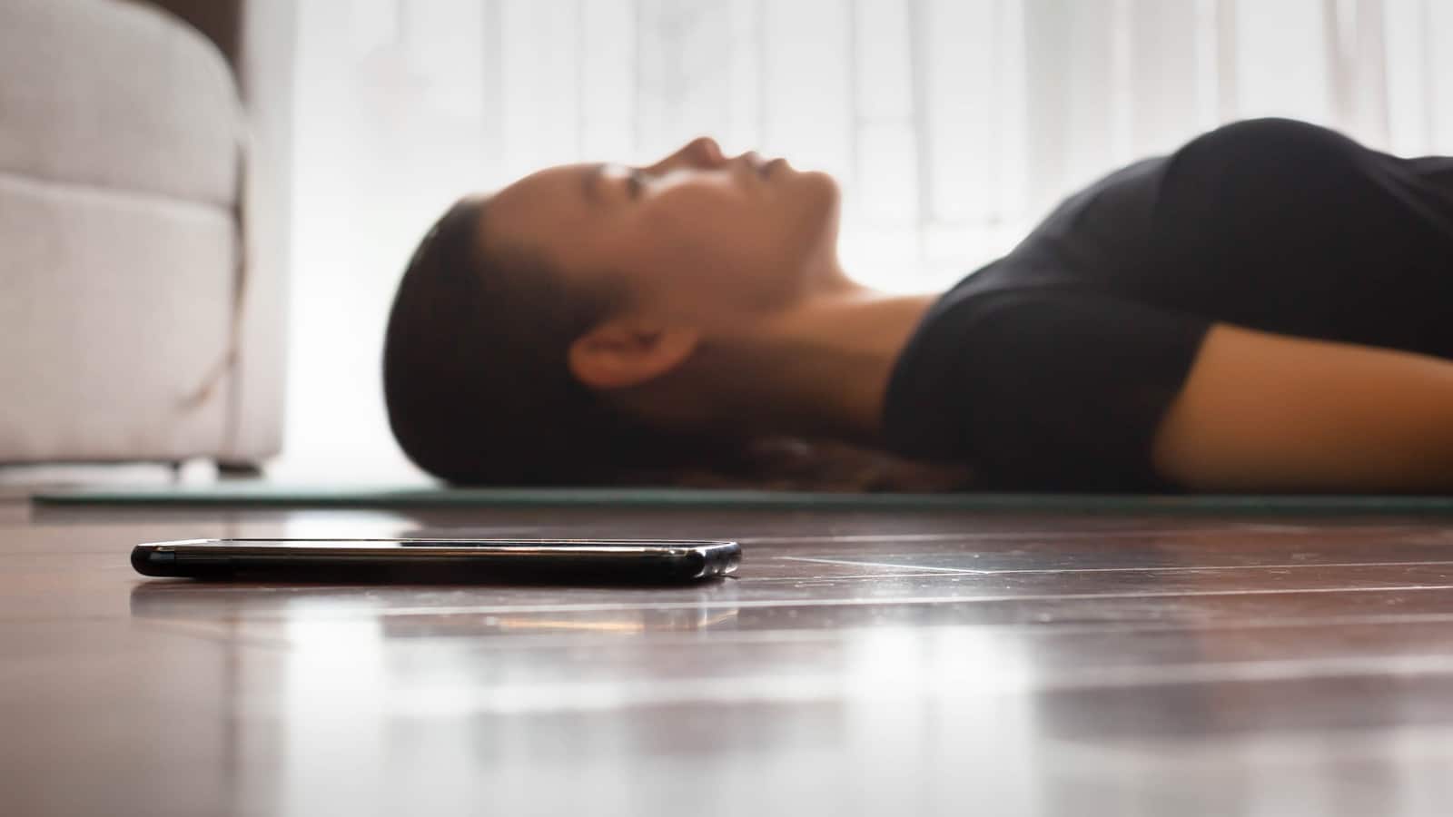 woman laying on floor meditating