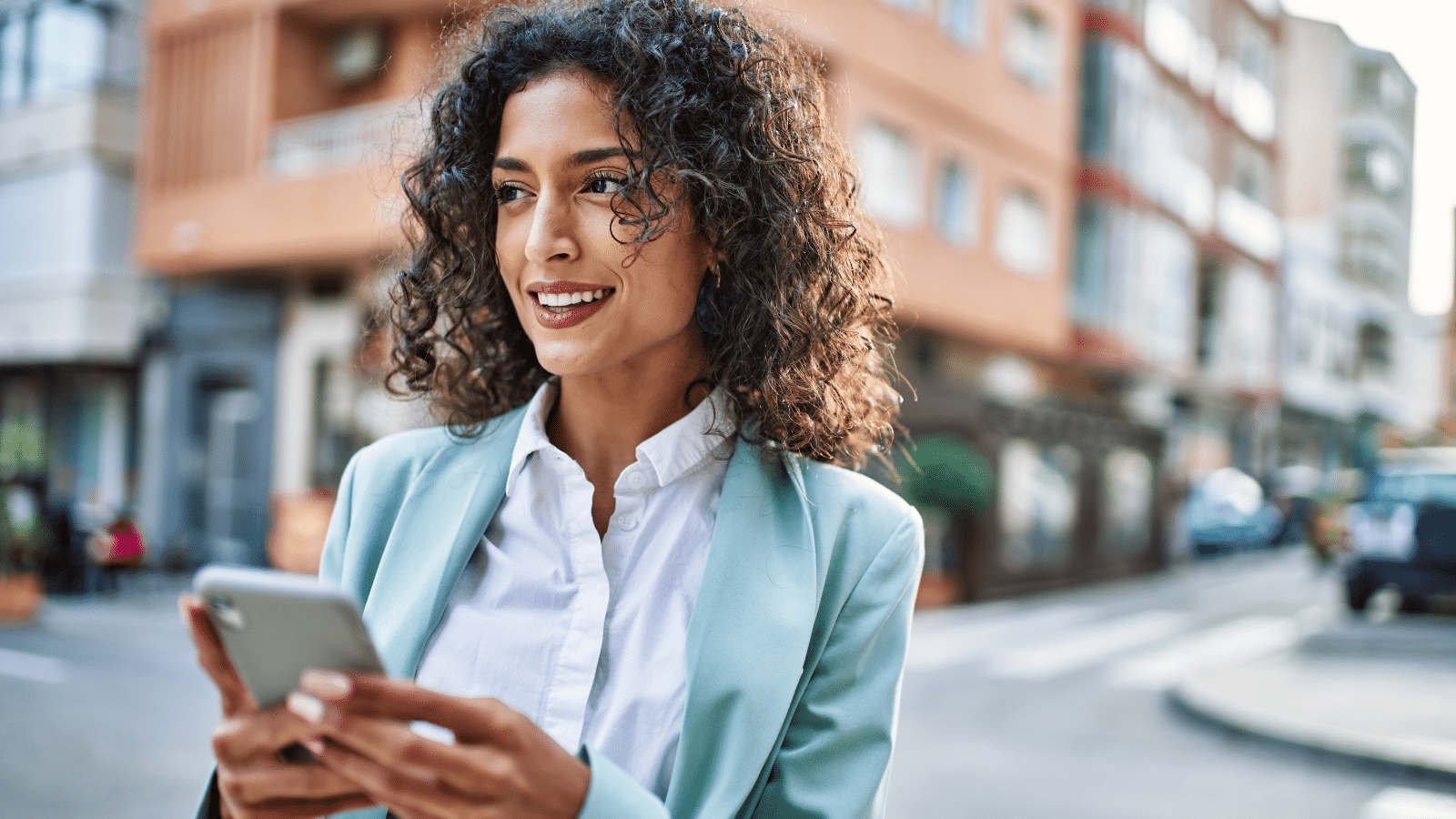 Business woman wearing professional look smiling confident at the city using smartphone.