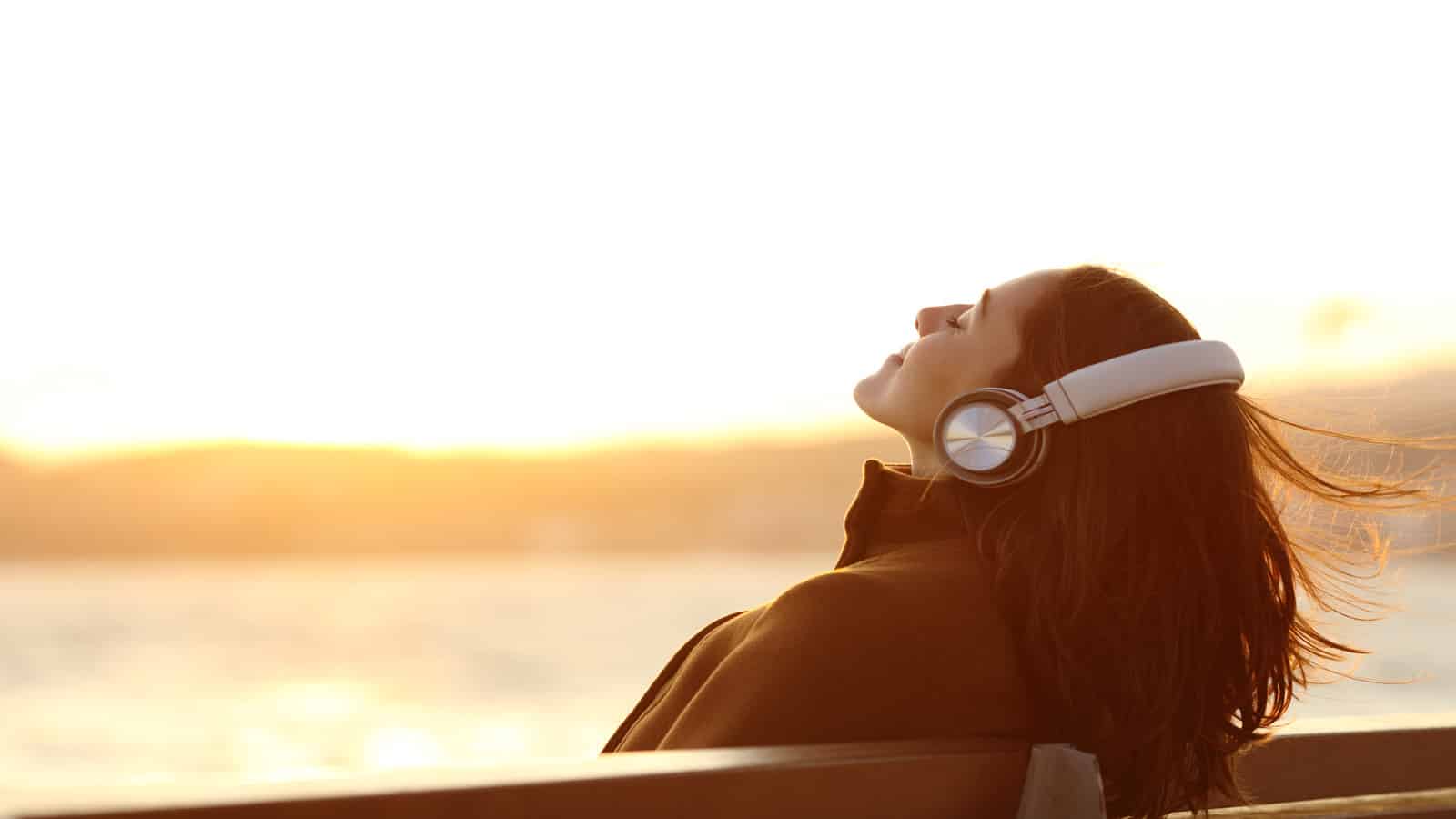 woman outside headphones meditating