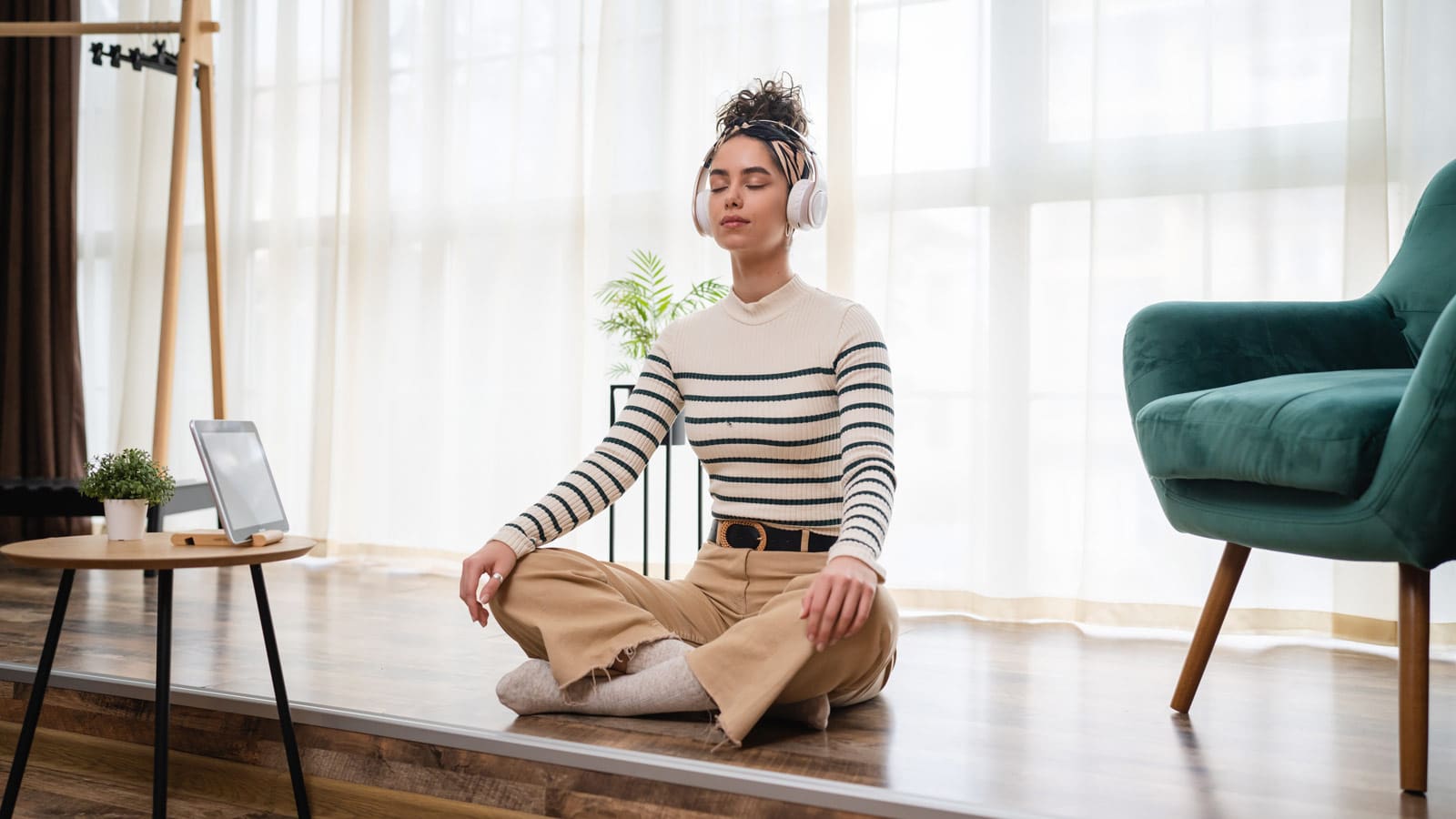 young woman meditating headphones