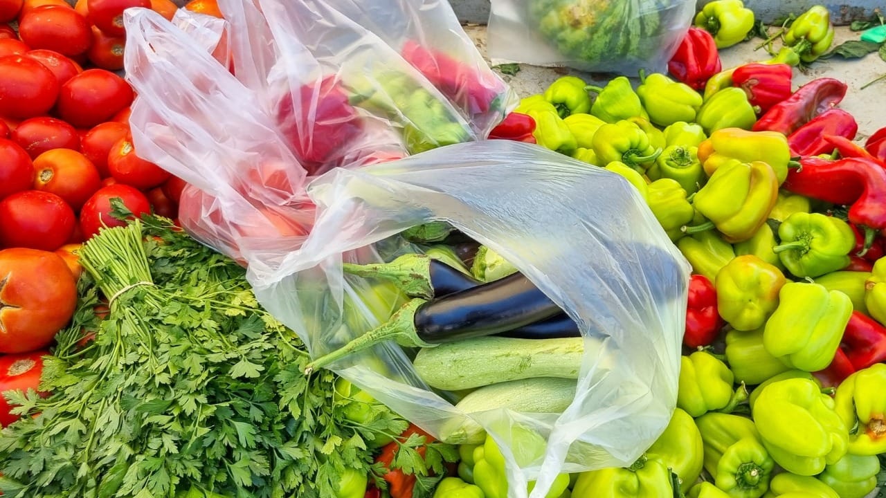 Grocery shopping at the farmers market with single-use plastic bags.