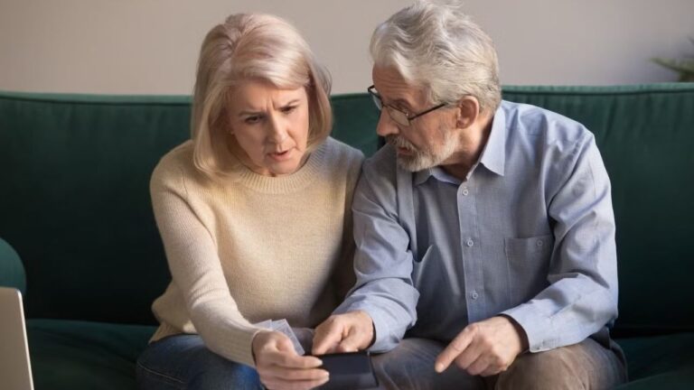 Serious stressed senior old couple worried about paperwork discuss finances.