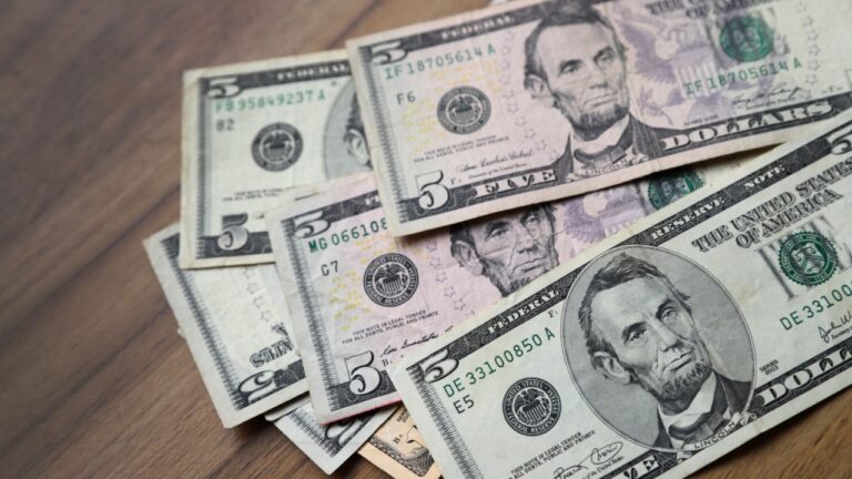 Us dollar bills. 5 dollar bills. Cash on a table. Concept of money, finance, economy, savings, earnings, salary, payment, currencies.