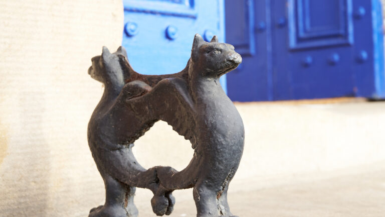 Ornate boot scraper outside a doorway