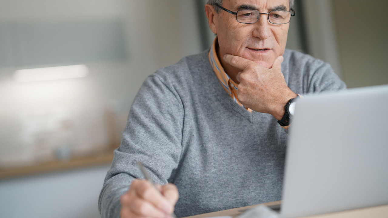 Senior-man-at-home-connected-on-laptop-computer