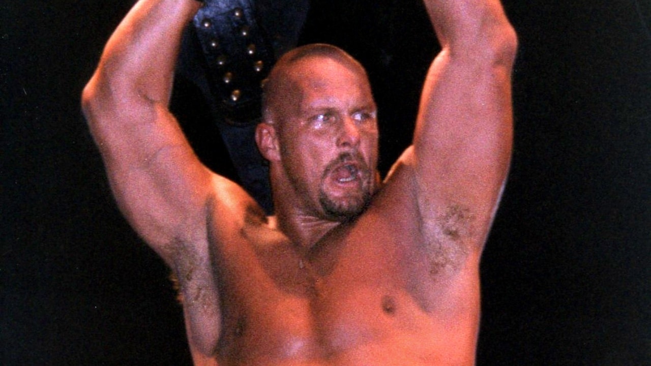 WWF Champion Stone Cold Steve Austin, holding his belt.
