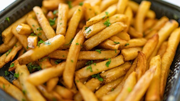 Truffle oil fries topped with cracked salt and pepper and parsley.