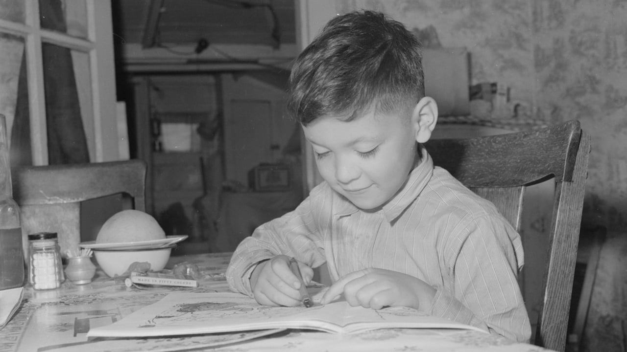 A young boy coloring