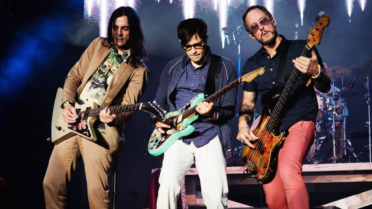 Weezer performing live on stage.