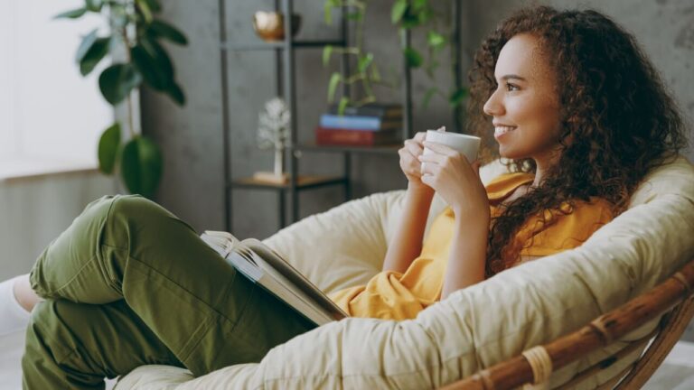 Woman relaxing reading a book drinking coffee