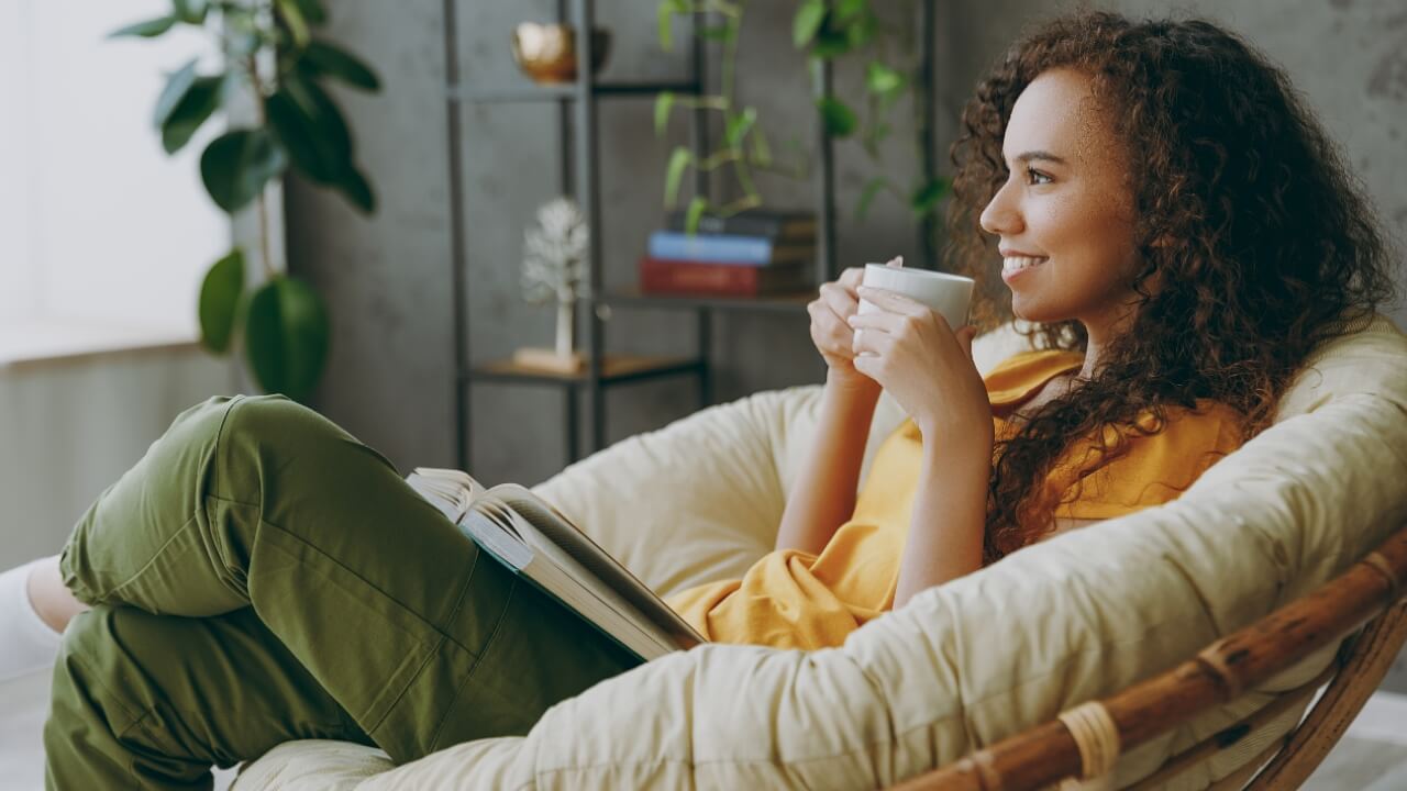 Woman relaxing reading a book drinking coffee