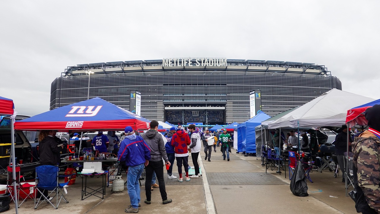 Fans enjoy tailgating at MetLife Stadium before a football game.