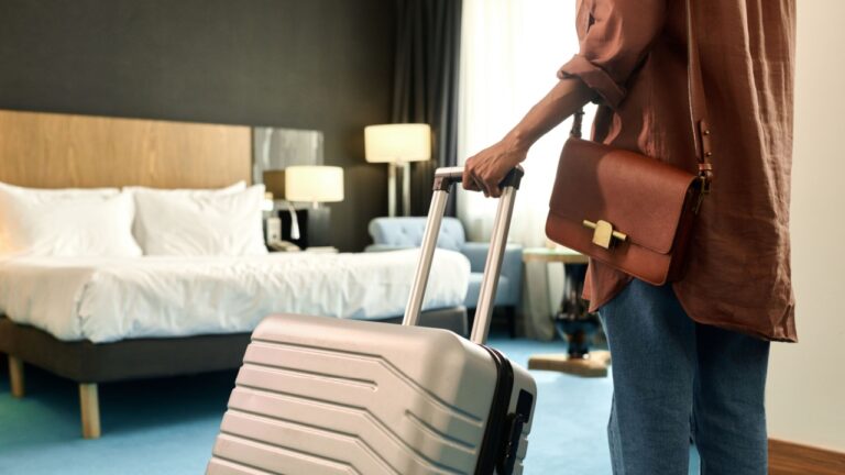 woman in hotel room with luggage