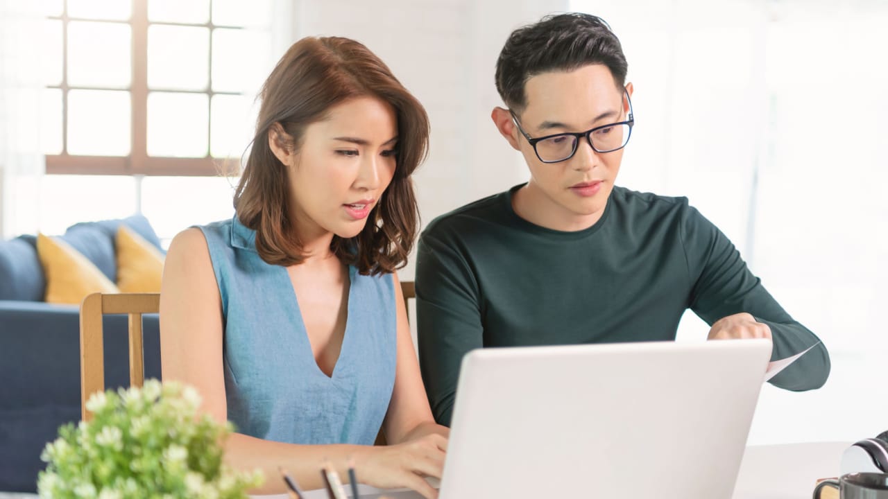 husband checking analyzing statement utilities bills sitting together at home. mortgage payments interest rates house buying