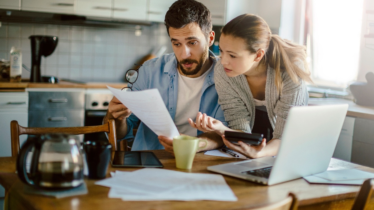 Young couple reading financial report