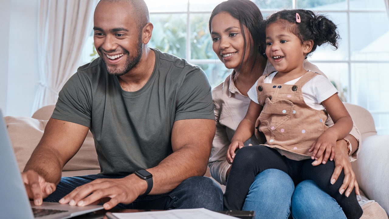 A happy family looking at a laptop
