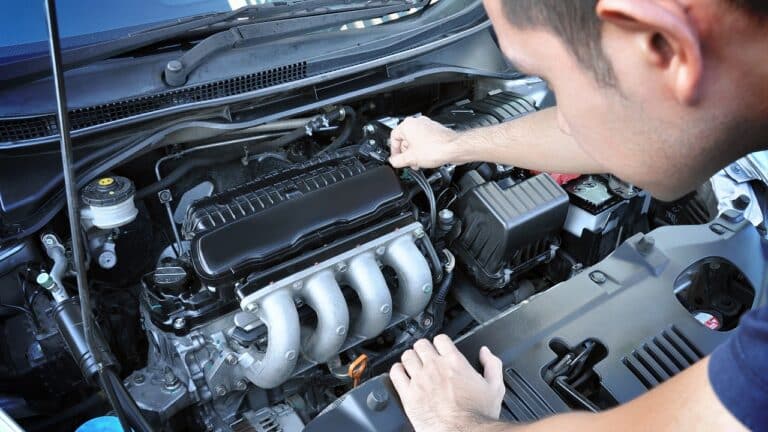 A man checking car engine