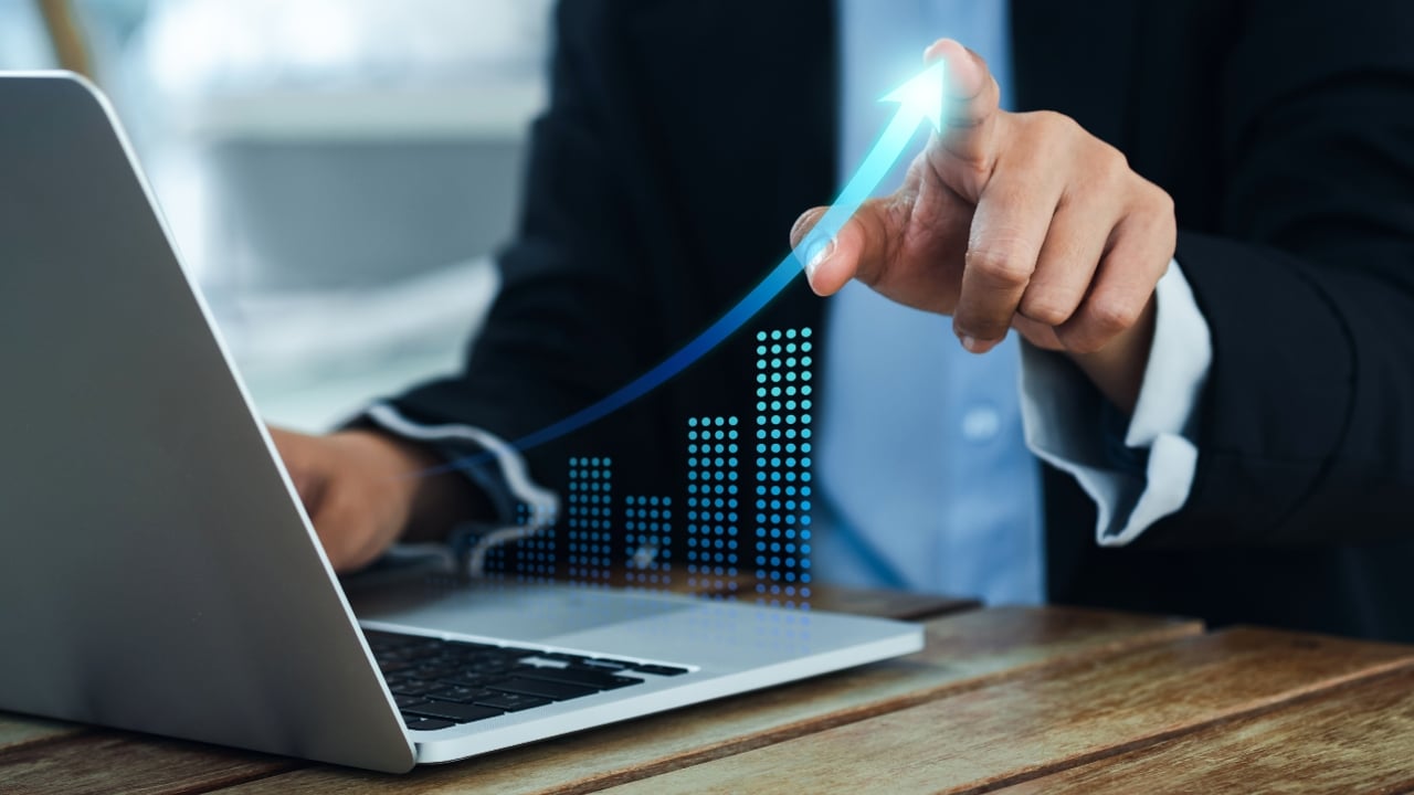 Laptop with graph showing increase in finances, invest, investments, goals, business, money, planning, retirement
