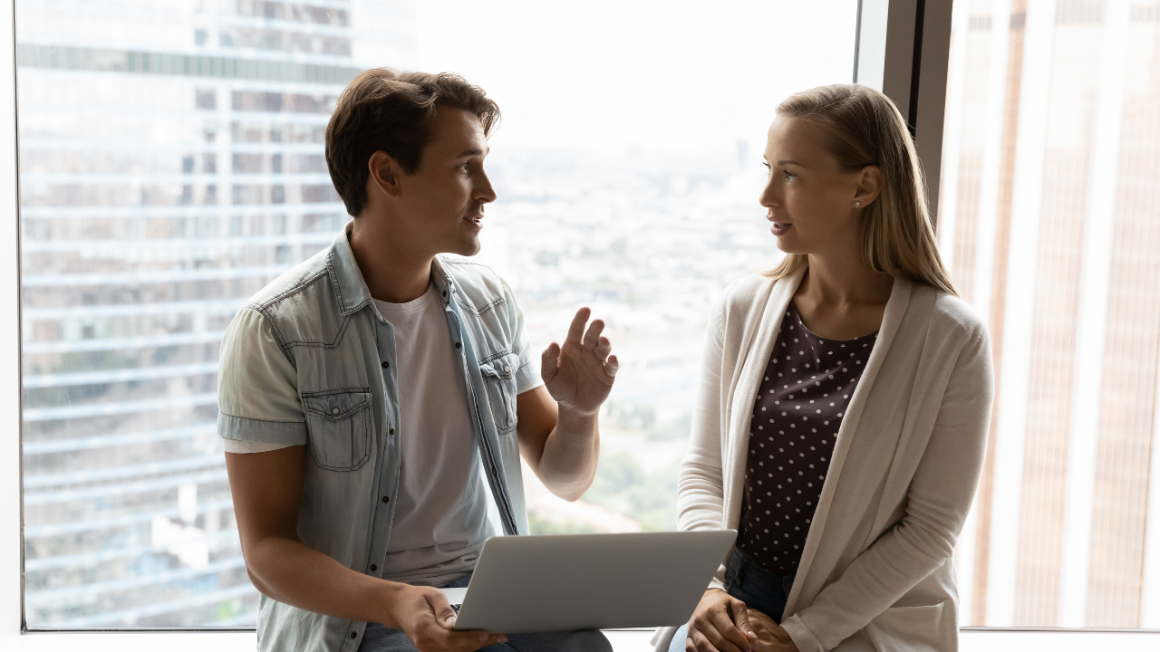 One professional guiding another, helping train the new hire, or mentoring
