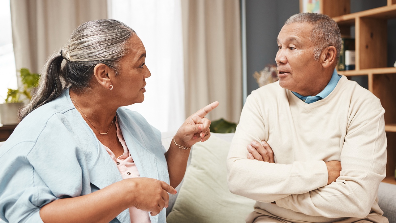 Senior couple, fight and angry on sofa for marriage problems, conflict and communication.