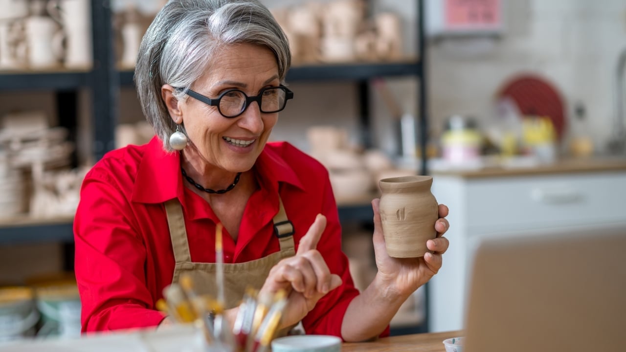 A woman holding pottery in her hand