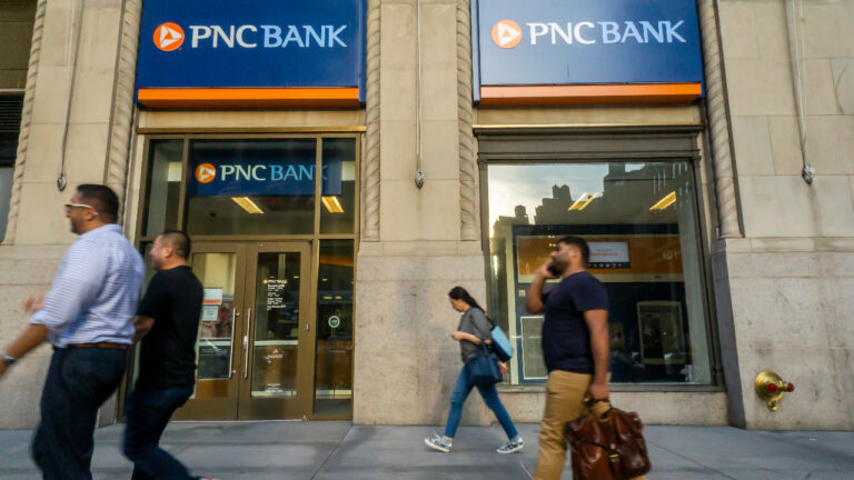 People walking past PNC Bank branch in New York City