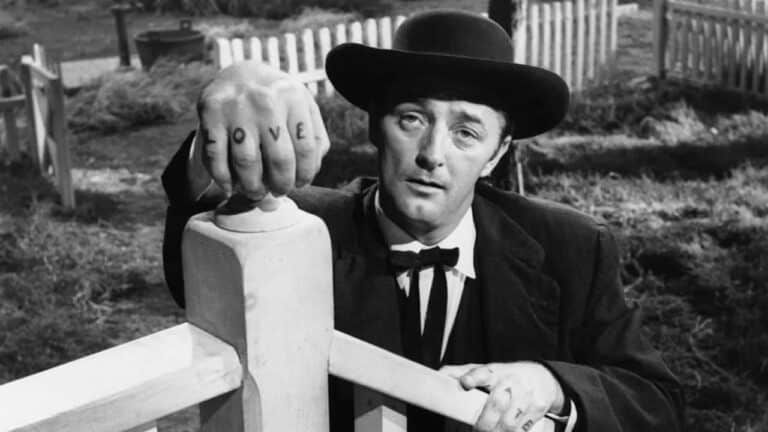 Robert Mitchum looks up stairs in The Night of the Hunter (1955)