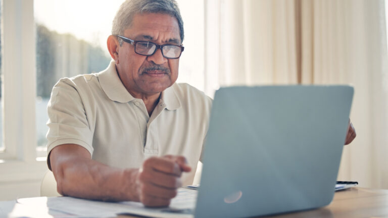 Senior man laptop and documents in finance or budget planning