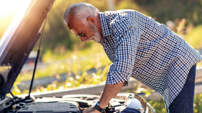 Senior man having problem with a car. Broken down car on the road.