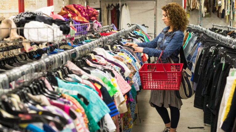 A woman walking around, shopping at a thrift store.