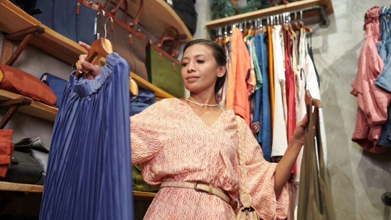 Young woman buying clothes in fashion boutique.