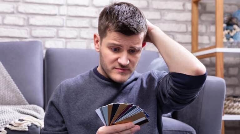 Stressed,Man,Looking,At,Too,Many,Credit,Cards,In,Home