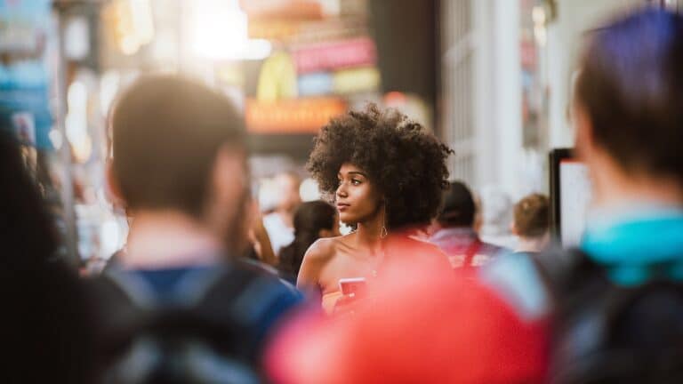 Young beautiful girl walking in Time square, manhattan