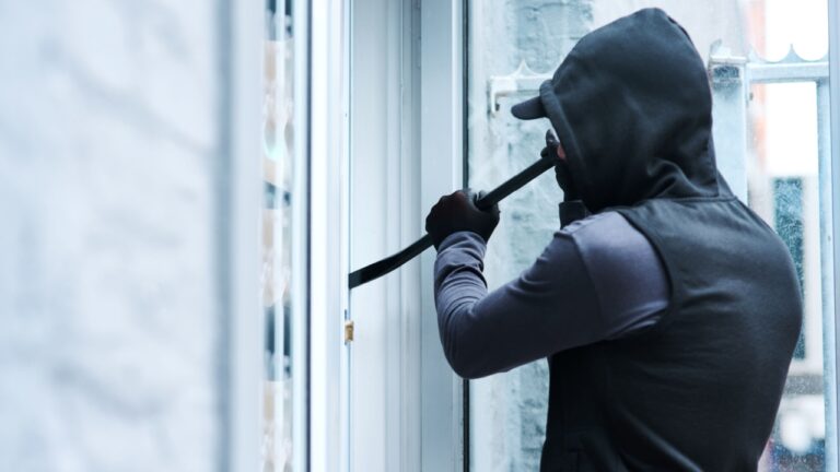 Man, criminal and crowbar for house crime, home invasion and breaking entering attempt with tool. Apartment, robbery and burglary or trespassing on property, security breach and owners safety risk.