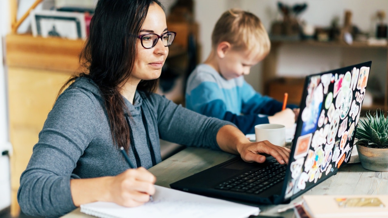 mom working from home next to child