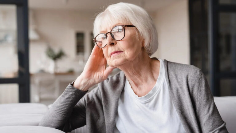 An older woman looking stressed.
