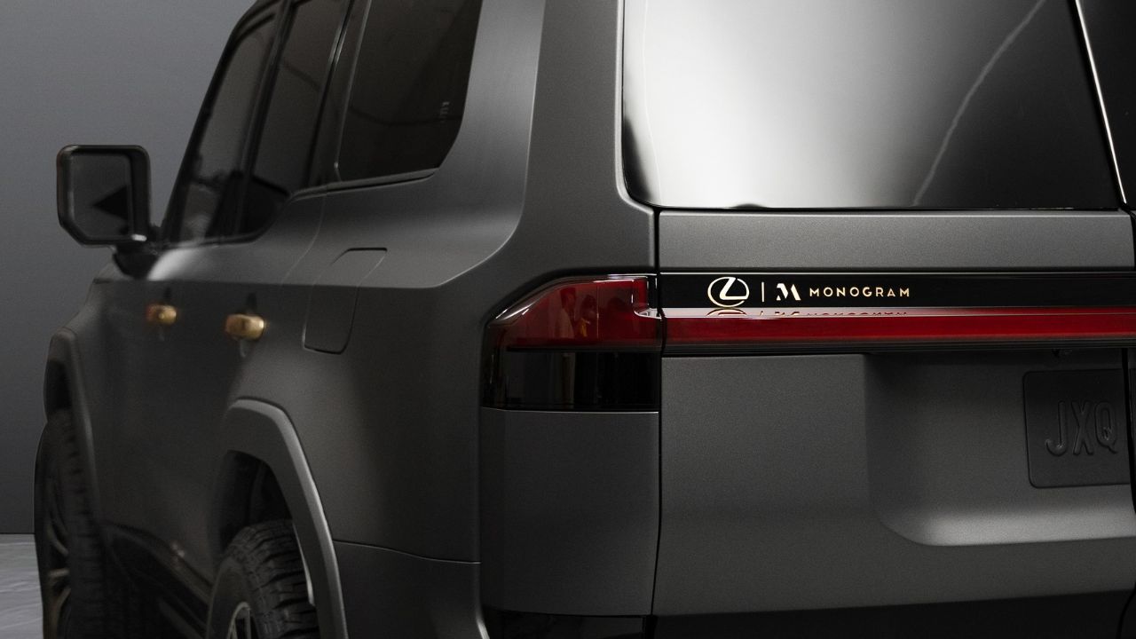 The rear and side view of the 2024 Lexus GX Monogram, showing golden detail on the vehicle and the golden nomenclature above the rear taillights.