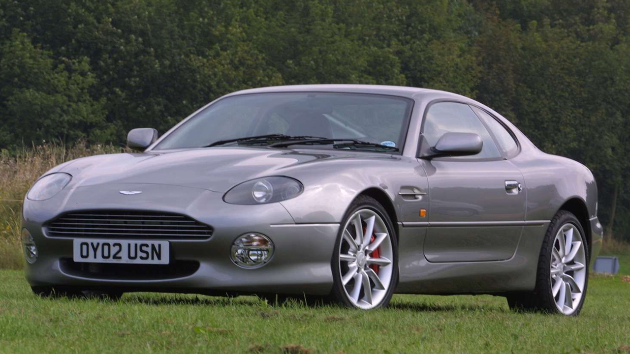 Aston Martin DB7 Vantage, front 3/4 view, silver exterior, field.