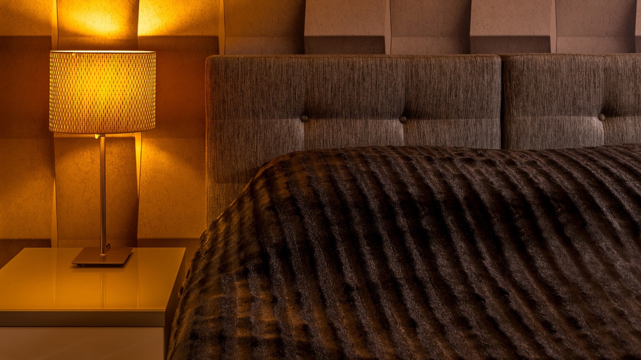 Minimal, modern warm-tone bedroom lighting against a 3-dimensional textured wall behind a headboard. 