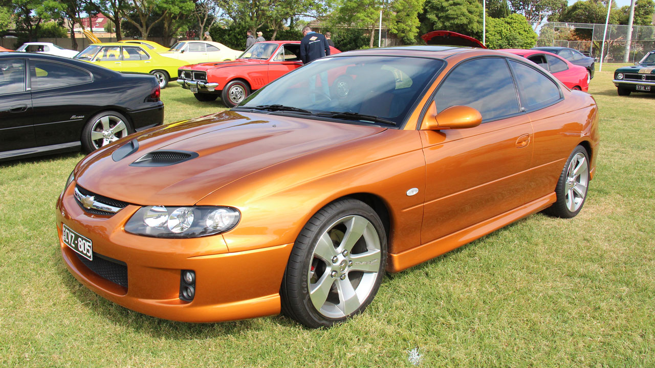 Chevrolet Lumina Coupe, front 3/4 view, orange exterior, auto show
